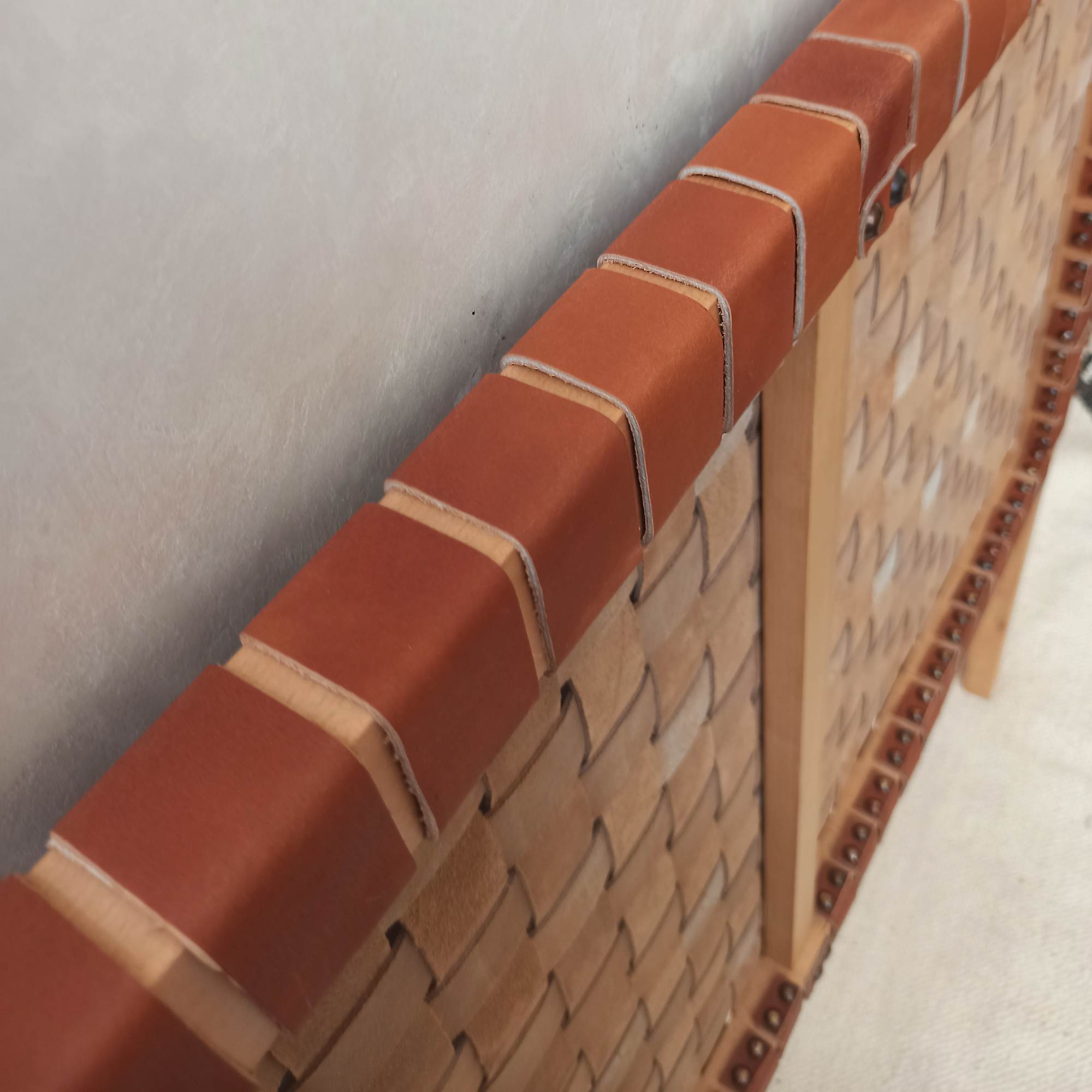 Handmade leather headboard, merging rustic charm with luxurious feel.