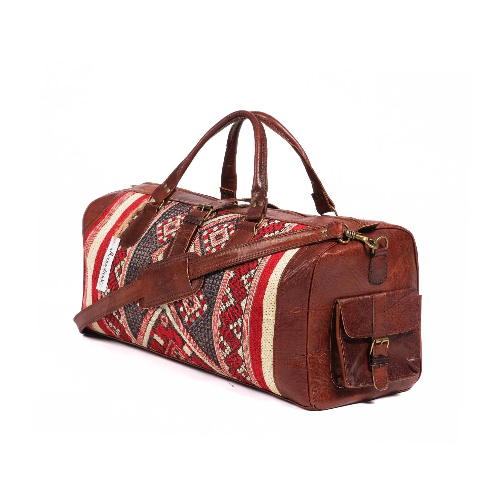 A handcrafted brown leather duffel bag with a kilim design, featuring a shoulder strap and side pockets.