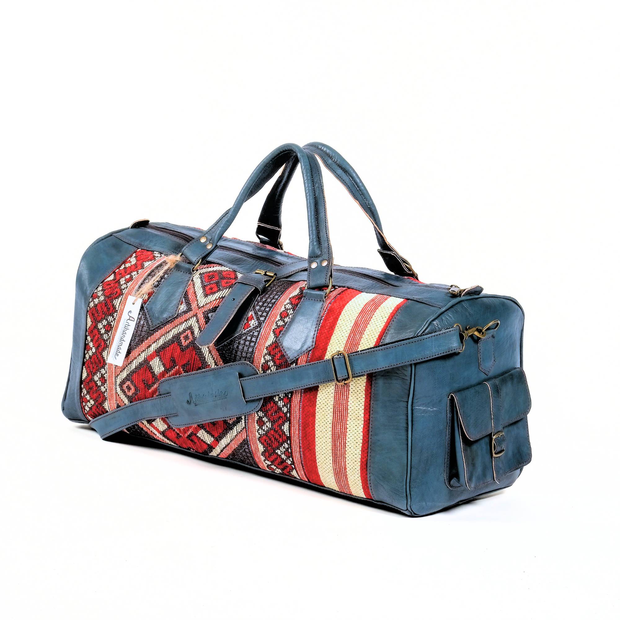 A handcrafted leather duffle bag with a blue and red kilim design, featuring a rich blue leather exterior and a medium-sized main compartment.