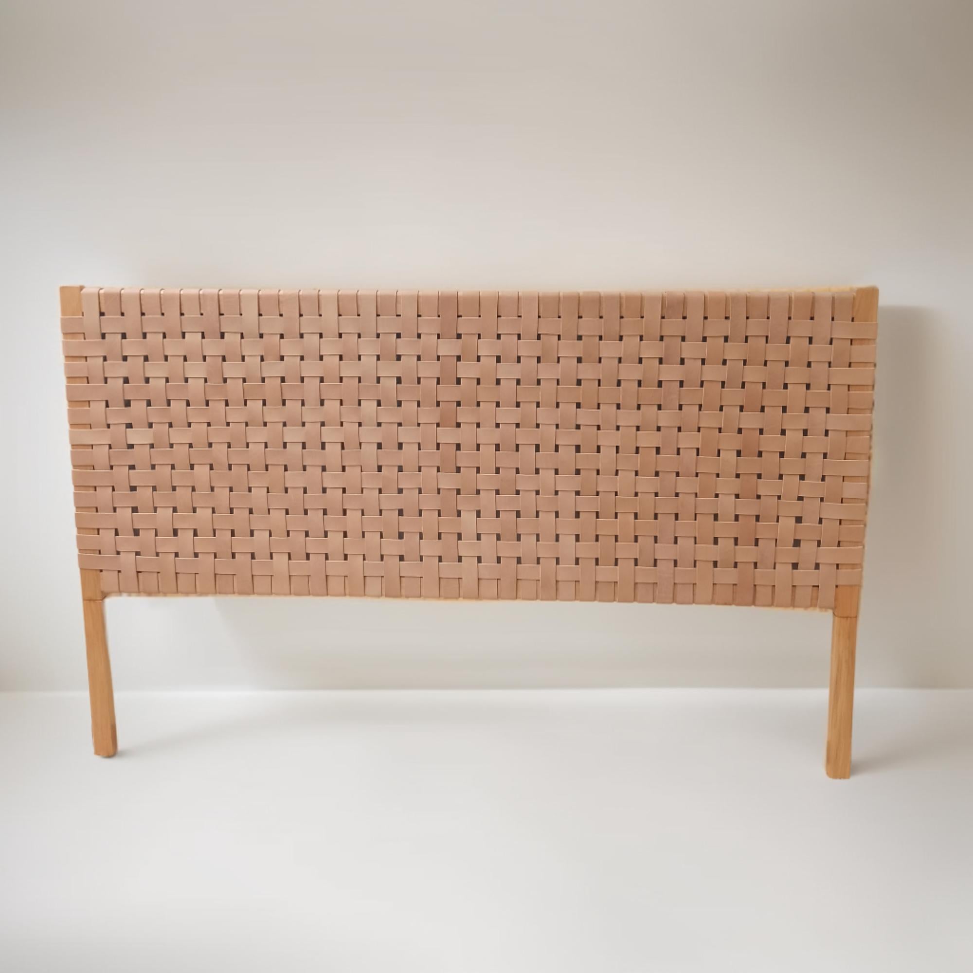 Detailed focus on the textured leather in a contemporary woven queen headboard.