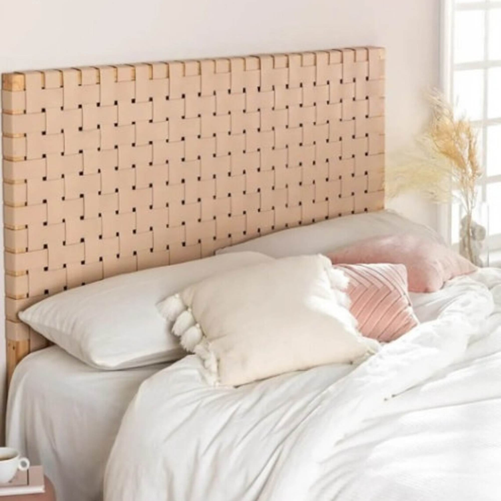 Side angle showing leather strap detail and carved wood frame