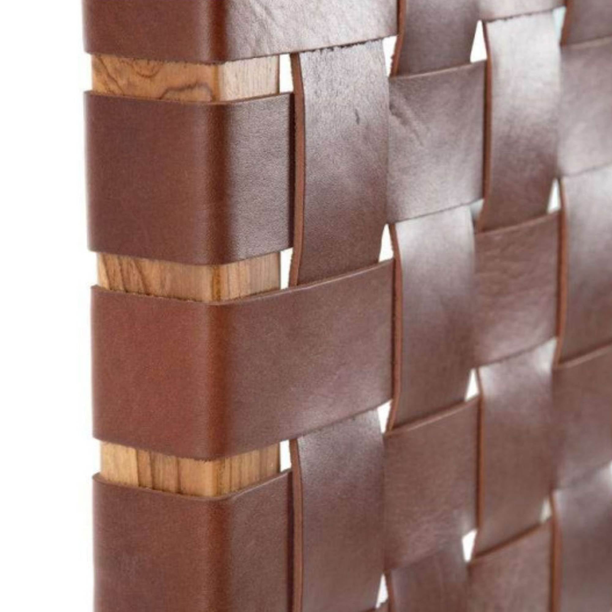 Rustic leather headboard with bohemian charm, a unique bedroom centerpiece.