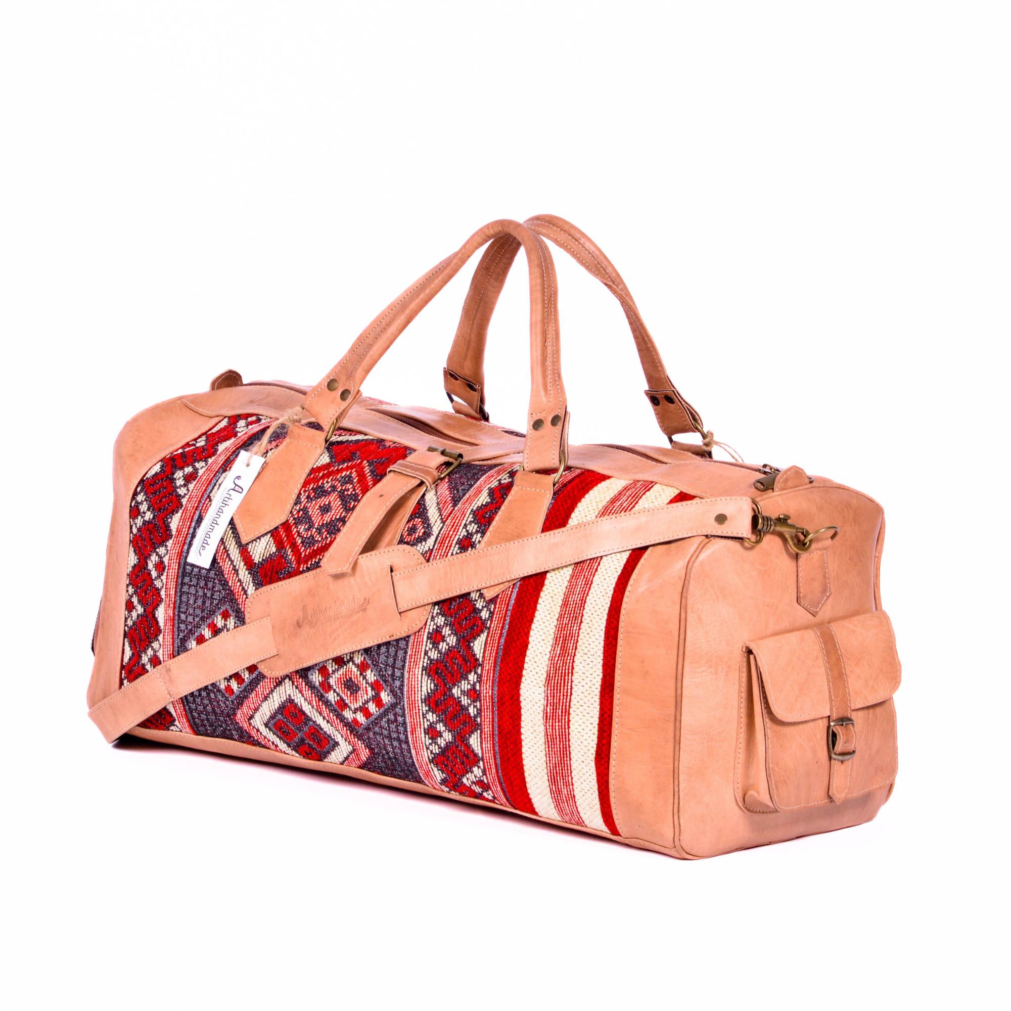 A tan natural leather duffel bag with a kilim design, featuring a shoulder strap and side pockets.