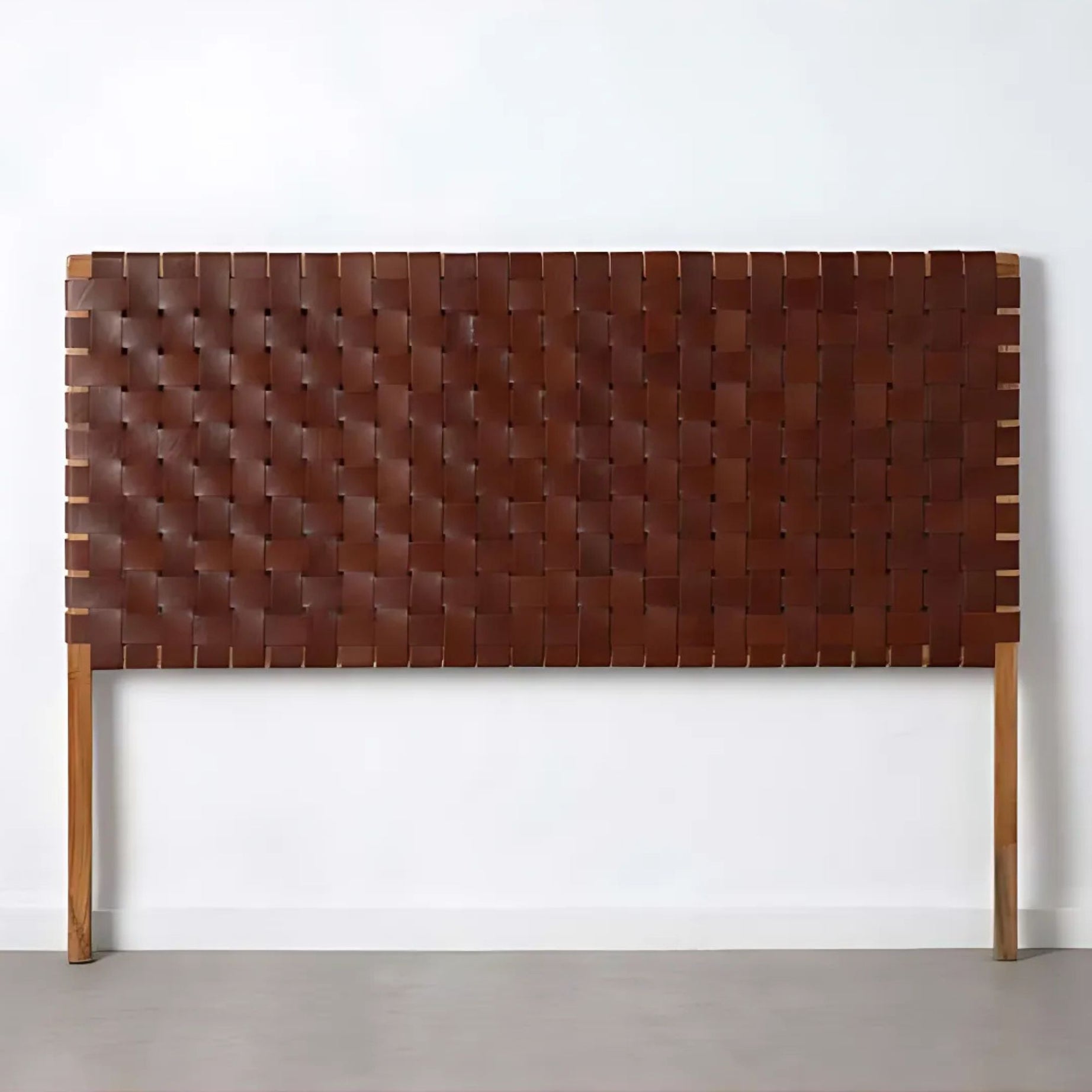 Detail of Artihandmade® full grain leather headboard, showcasing hand-tooled strap texture.