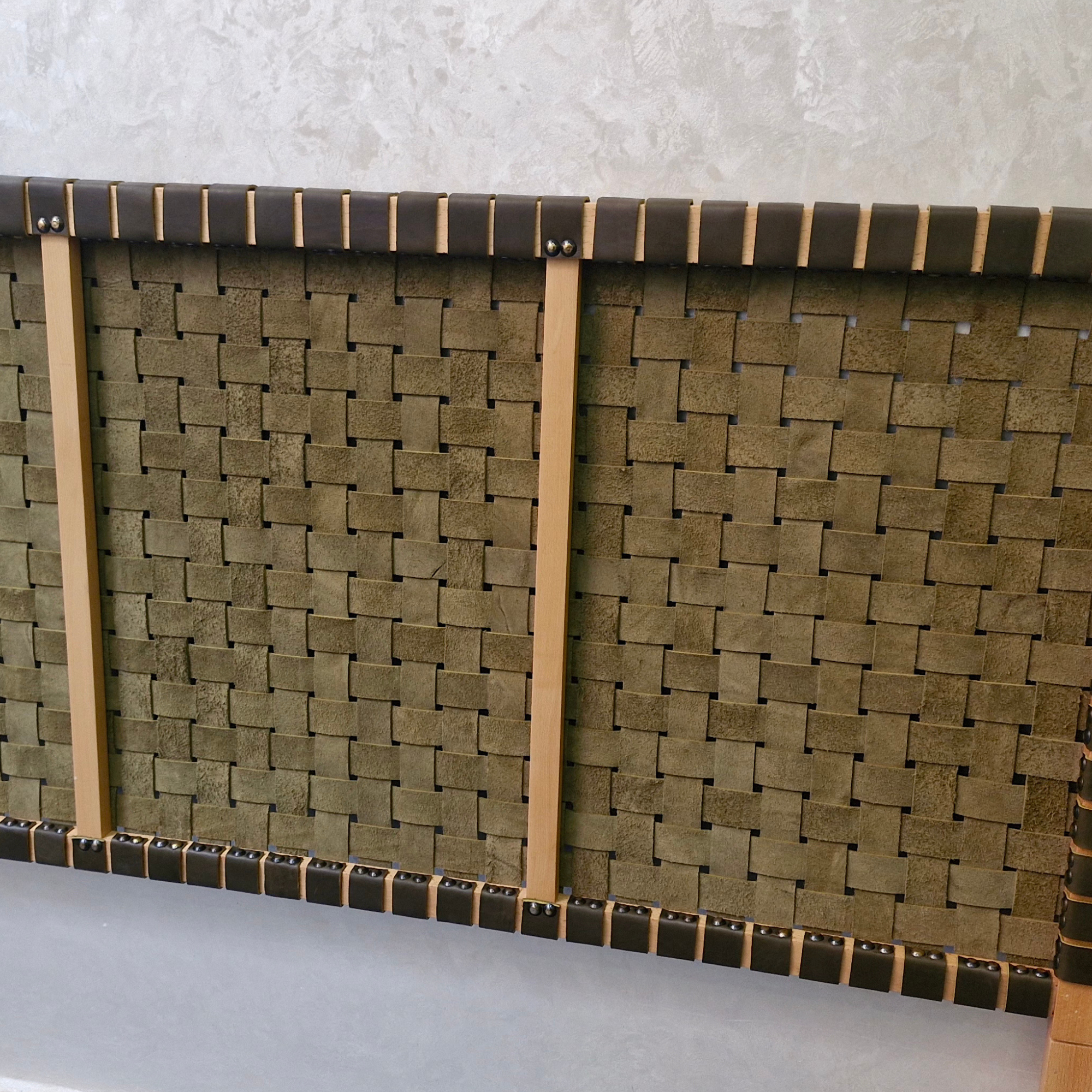 Woven mat with wooden frame on a gray surface