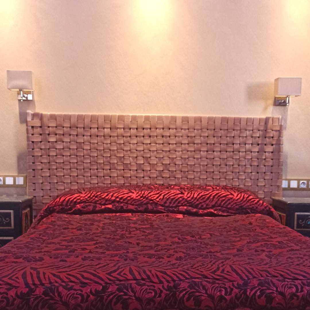 Elegant leather headboard with a focus on its unique craftsmanship and natural texture details